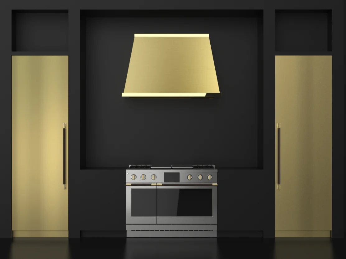Monogram brass collection featuring refrigerator panels, a hood and professional range